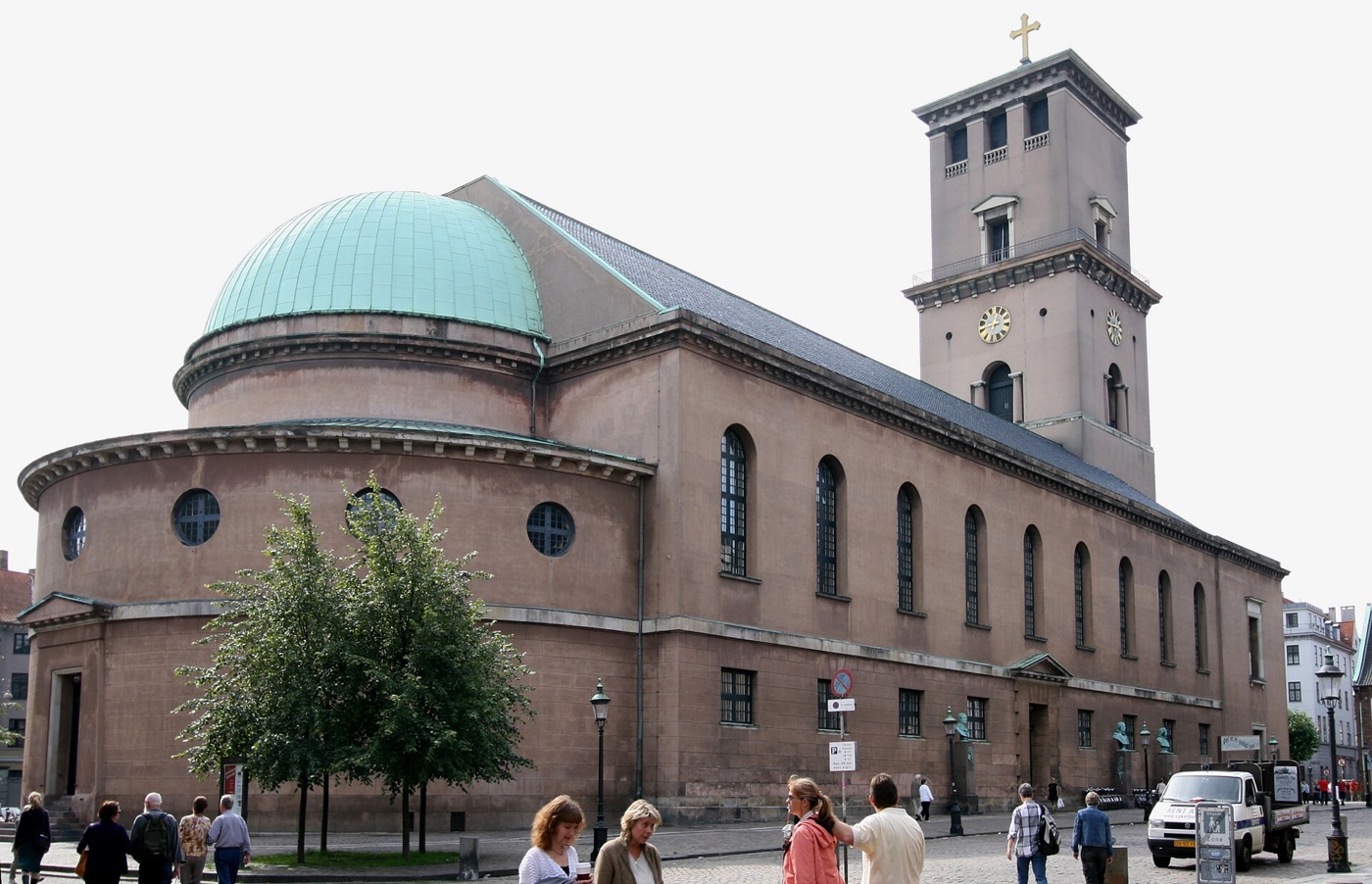 The pale stone front and square tower of the Church of Our Lady seen from the street